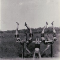 Athletic group practicing routines on bars in Intola
